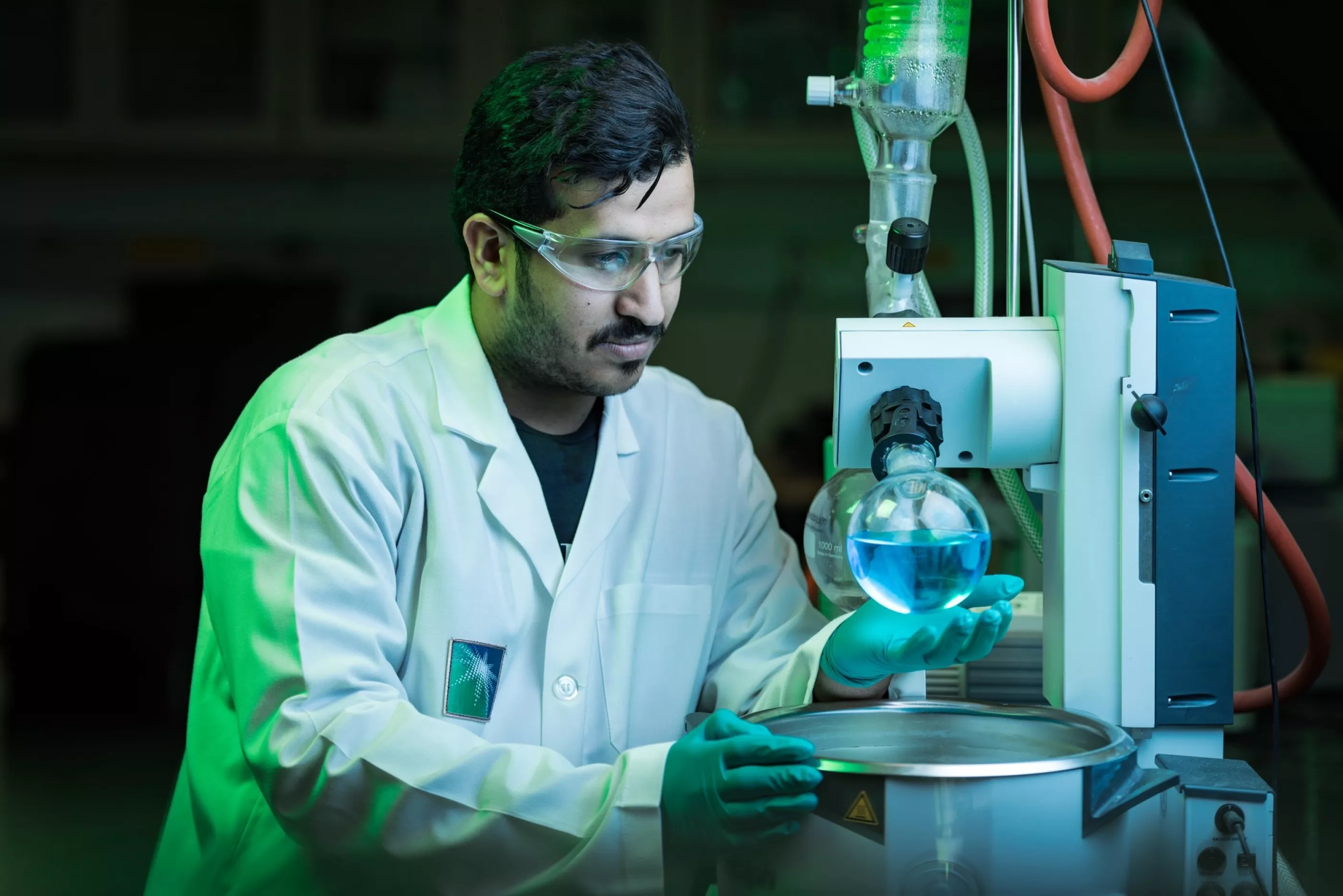 Aramco chemical lab technician testing blue liquid