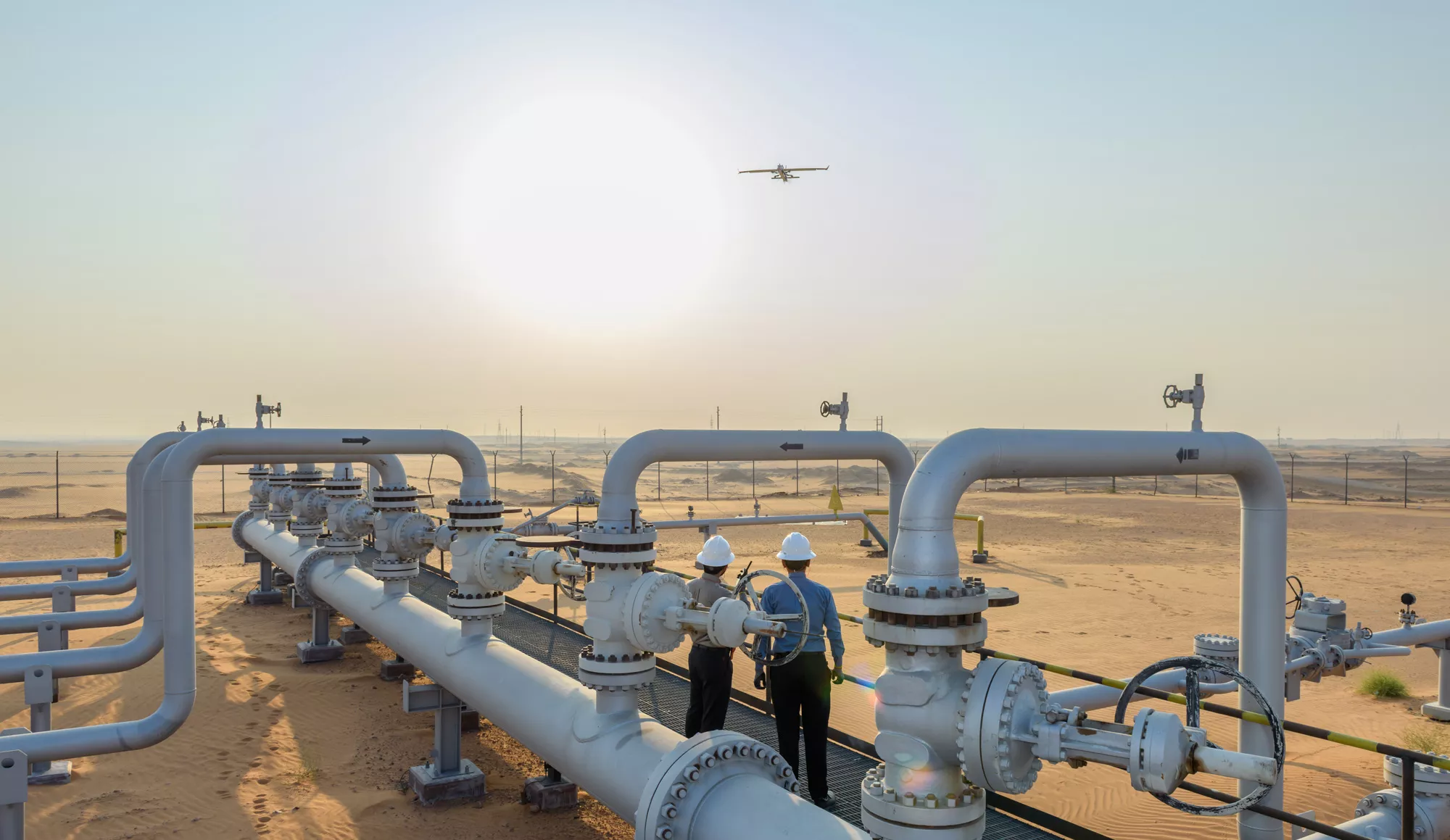 A fixed-wing drone flies over the Khurais field